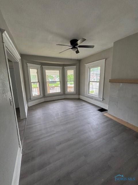 3239 Cherry St, Toledo, OH 43608 - unfurnished living room featuring ceiling fan, dark wood-style floors, and baseboards
