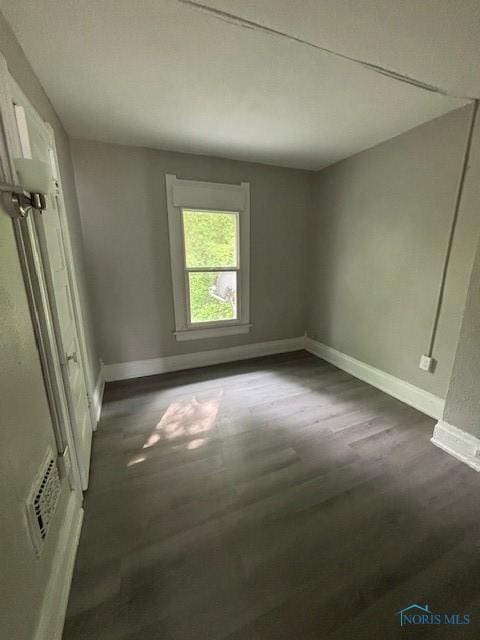 3239 Cherry St, Toledo, OH 43608 - unfurnished bedroom featuring dark wood-type flooring and baseboards