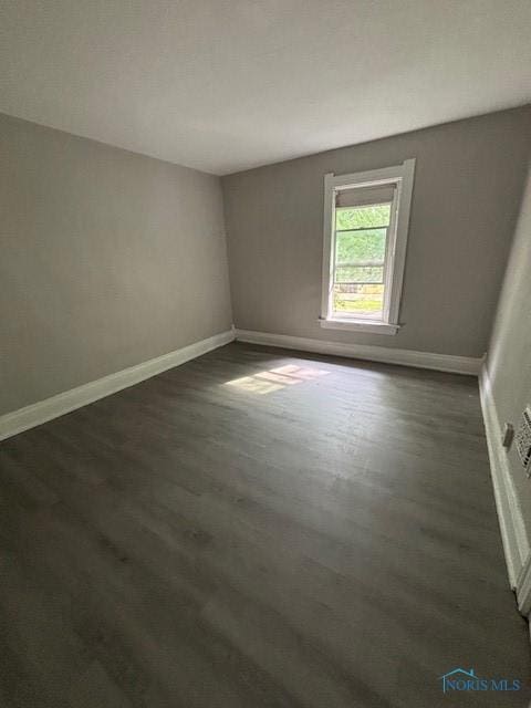3239 Cherry St, Toledo, OH 43608 - empty room with baseboards and dark wood finished floors
