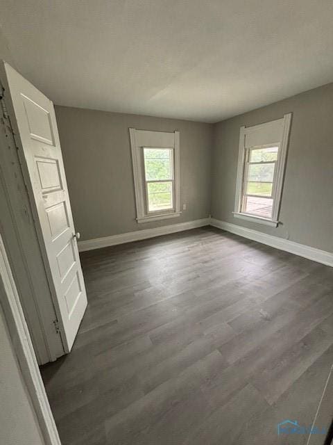 3239 Cherry St, Toledo, OH 43608 - empty room featuring plenty of natural light, baseboards, and dark wood-type flooring