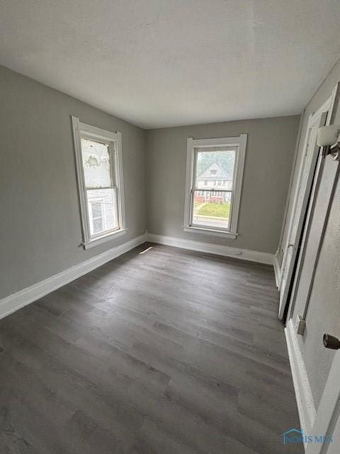 3239 Cherry St, Toledo, OH 43608 - unfurnished room with dark wood-style flooring and baseboards