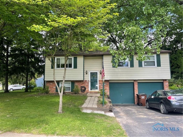 2628 Fairbanks Ave, Toledo, OH 43615 - bi-level home featuring asphalt driveway, an attached garage, a front yard, and brick siding