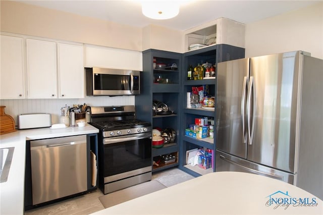 1133 Cuba St, Toledo, OH 43615 - kitchen with stainless steel appliances, light countertops, and white cabinetry