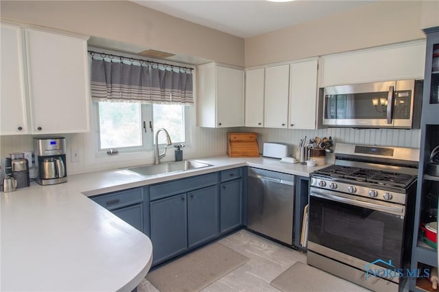 1133 Cuba St, Toledo, OH 43615 - kitchen featuring appliances with stainless steel finishes, a sink, light countertops, and white cabinets