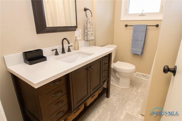 1133 Cuba St, Toledo, OH 43615 - bathroom with vanity, toilet, and baseboards