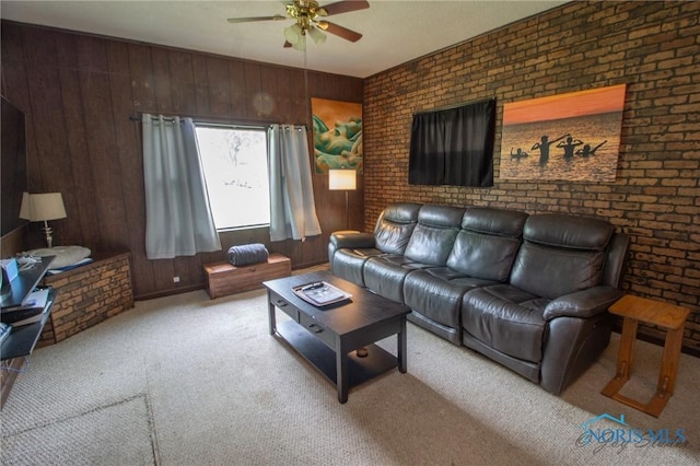 1133 Cuba St, Toledo, OH 43615 - carpeted living area featuring a ceiling fan, wooden walls, and brick wall