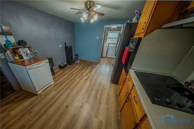 327 Klingler Rd, Paulding, OH 45879 - kitchen featuring brown cabinetry, black electric stovetop, light wood-style flooring, and a ceiling fan