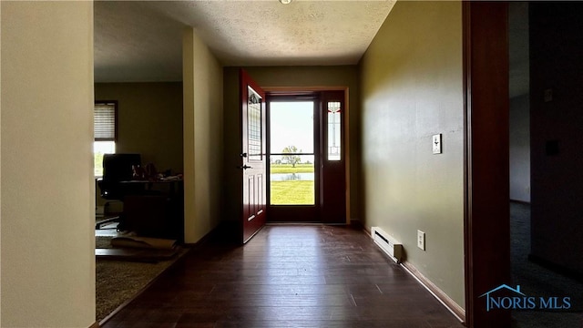 13926 Rd 154, Paulding, OH 45879 - foyer entrance with baseboard heating, dark wood-style floors, a textured ceiling, and baseboards