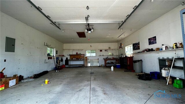 13926 Rd 154, Paulding, OH 45879 - garage featuring electric panel, a garage door opener, and a workshop area