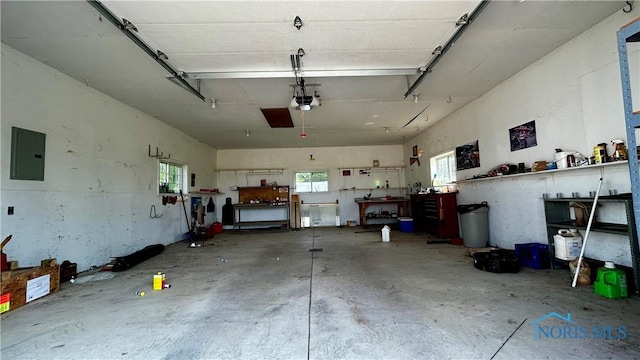 13926 Rd 154, Paulding, OH 45879 - garage featuring electric panel, a workshop area, and a garage door opener
