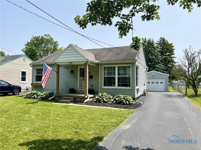 516 W 7th St, Perrysburg, OH 43551 - view of front of property featuring a garage, an outdoor structure, asphalt driveway, and roof with shingles