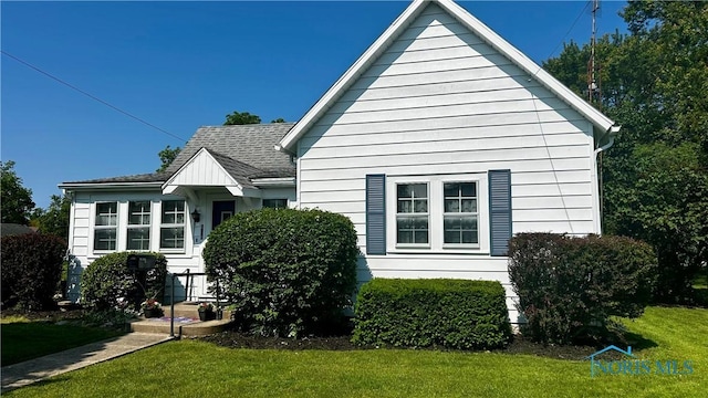 606 Lincoln Ave, Paulding, OH 45879 - back of house featuring a lawn and a shingled roof