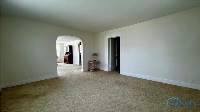 606 Lincoln Ave, Paulding, OH 45879 - carpeted spare room with arched walkways and baseboards