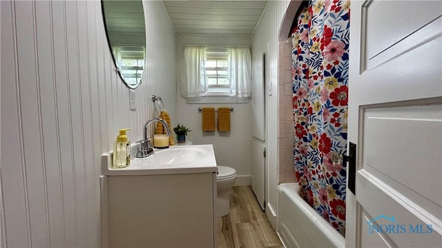 606 Lincoln Ave, Paulding, OH 45879 - bathroom featuring vanity, wood finished floors, toilet, shower / bathtub combination with curtain, and wooden walls