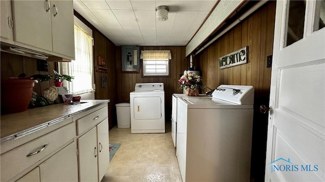 606 Lincoln Ave, Paulding, OH 45879 - laundry room with washing machine and dryer, wooden walls, cabinet space, and electric panel