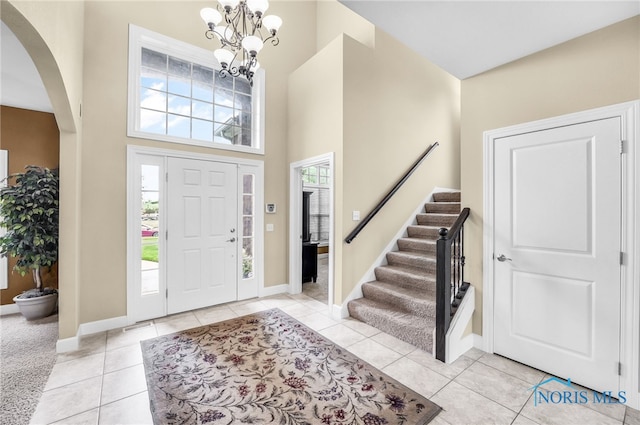 4360 Turtle Creek Dr, Perrysburg, OH 43551 - entryway with arched walkways, a chandelier, stairway, baseboards, and a high ceiling