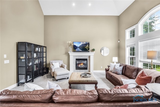 4360 Turtle Creek Dr, Perrysburg, OH 43551 - living room featuring carpet floors, a towering ceiling, baseboards, and a tile fireplace