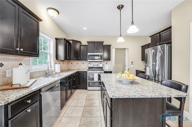 4360 Turtle Creek Dr, Perrysburg, OH 43551 - kitchen with appliances with stainless steel finishes, a sink, a kitchen island, and tasteful backsplash
