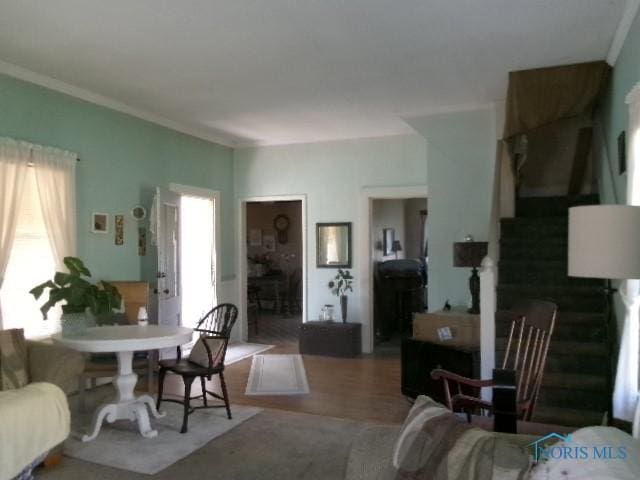 616 E 4th St, Ottawa, OH 45875 - living area featuring stairs, wood finished floors, and ornamental molding
