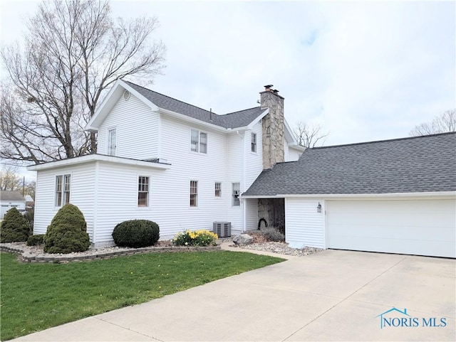 313 E Lynn St, Edgerton, OH 43517 - view of home's exterior featuring a chimney, central air condition unit, a garage, a yard, and concrete driveway