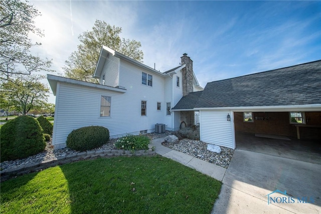 313 E Lynn St, Edgerton, OH 43517 - rear view of property with a chimney, central AC, a yard, and driveway