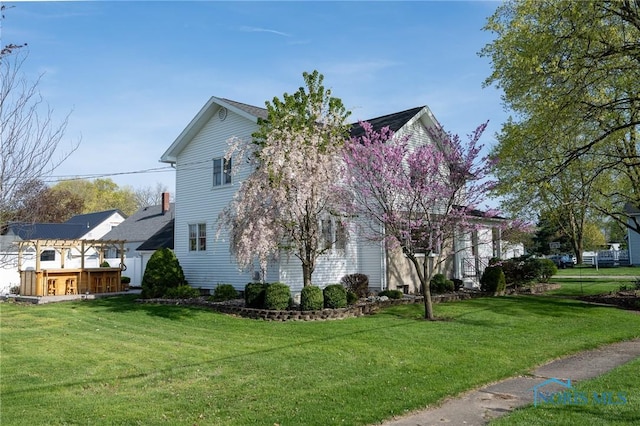 313 E Lynn St, Edgerton, OH 43517 - view of side of property with a yard
