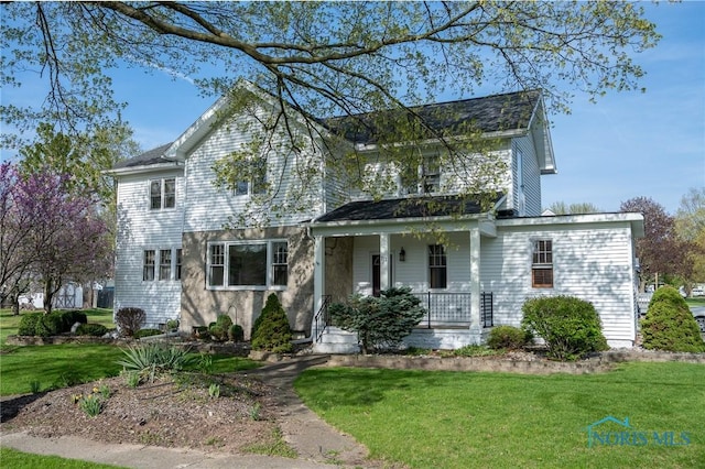 313 E Lynn St, Edgerton, OH 43517 - view of front facade with a porch and a front yard