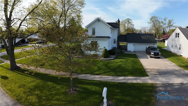 313 E Lynn St, Edgerton, OH 43517 - traditional-style house with concrete driveway, a chimney, a front yard, and an attached garage