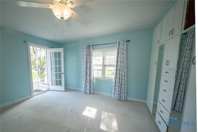 313 E Lynn St, Edgerton, OH 43517 - unfurnished bedroom featuring baseboards, access to outside, carpet floors, and a ceiling fan