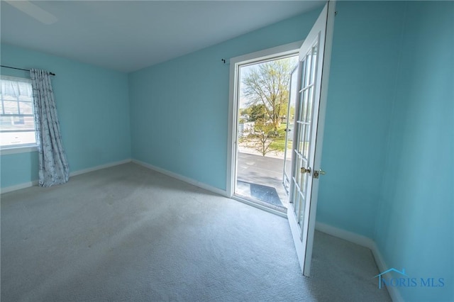 313 E Lynn St, Edgerton, OH 43517 - unfurnished room featuring baseboards, carpet, and french doors