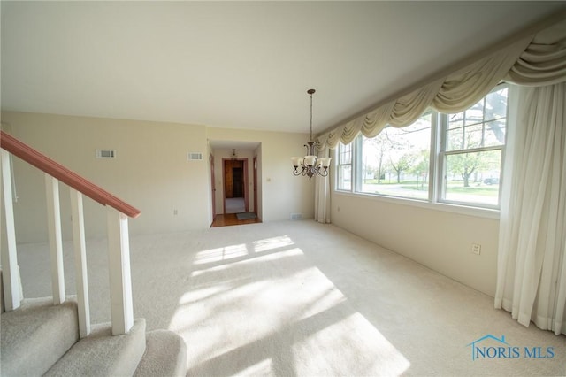 313 E Lynn St, Edgerton, OH 43517 - unfurnished dining area with a chandelier, light colored carpet, and stairway
