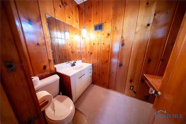 313 E Lynn St, Edgerton, OH 43517 - half bath featuring toilet, wood walls, and vanity