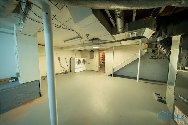 313 E Lynn St, Edgerton, OH 43517 - unfinished basement featuring washer and clothes dryer, electric panel, stairway, and heating unit