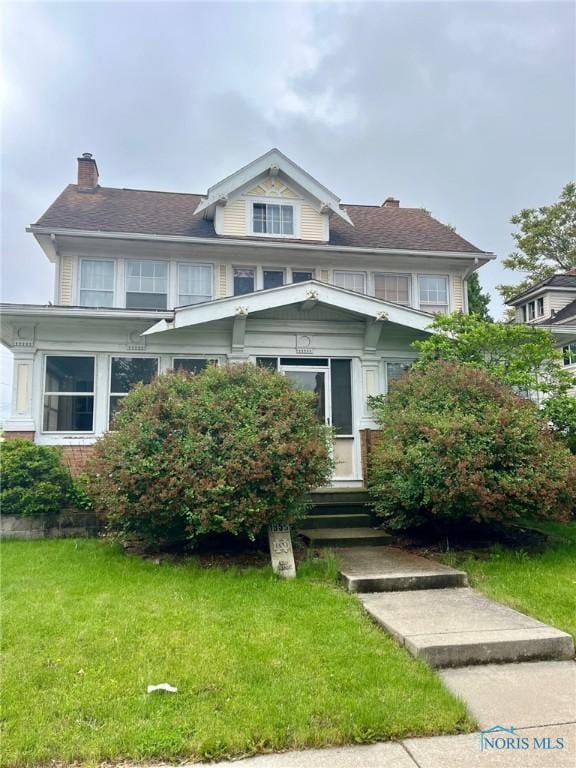 1855 Glendale Ave, Toledo, OH 43614 - view of front facade with a chimney, a front lawn, and entry steps