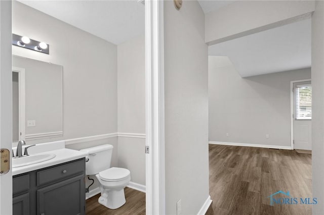 1141 Oriole Dr, Bowling Green, OH 43402 - bathroom with wood finished floors, toilet, vanity, and baseboards