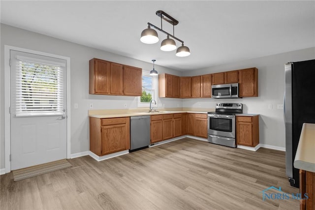 1141 Oriole Dr, Bowling Green, OH 43402 - kitchen featuring stainless steel appliances, light wood-style floors, light countertops, and a sink