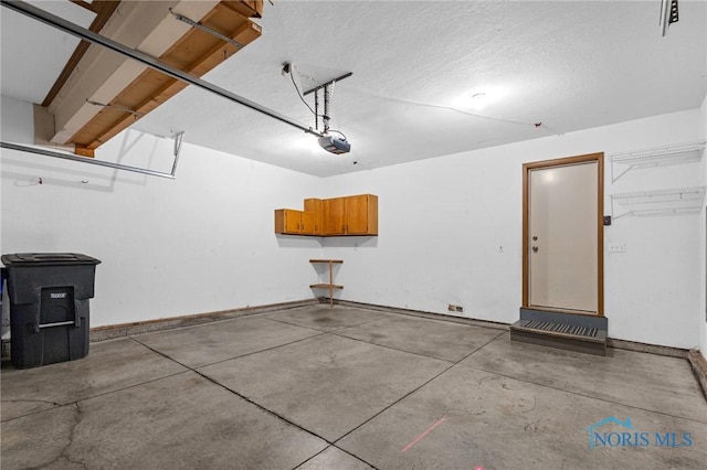 1141 Oriole Dr, Bowling Green, OH 43402 - garage with baseboards and a garage door opener