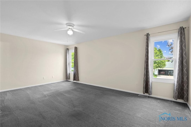 1141 Oriole Dr, Bowling Green, OH 43402 - empty room featuring ceiling fan, dark carpet, and baseboards