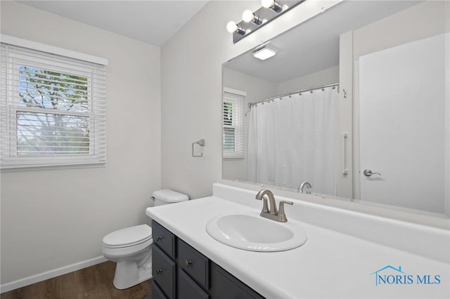 1141 Oriole Dr, Bowling Green, OH 43402 - bathroom featuring wood finished floors, vanity, baseboards, and toilet