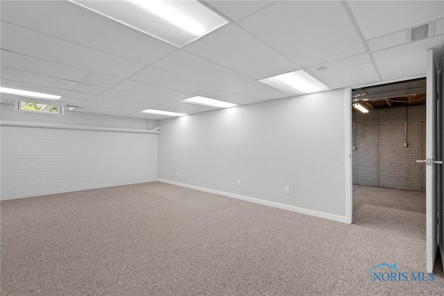 1141 Oriole Dr, Bowling Green, OH 43402 - below grade area featuring brick wall, carpet floors, baseboards, and a paneled ceiling