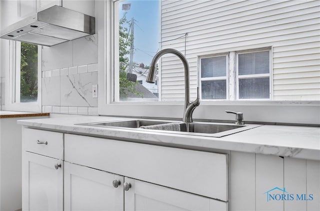 345 W Manhattan Blvd, Toledo, OH 43608 - kitchen featuring a sink, ventilation hood, white cabinets, and light stone counters
