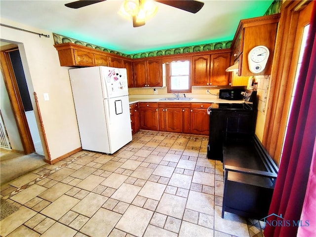 1050 Schultz St, Defiance, OH 43512 - kitchen featuring freestanding refrigerator, a sink, black range with electric cooktop, light countertops, and ceiling fan