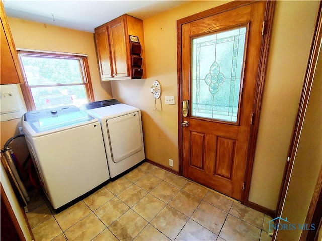 1050 Schultz St, Defiance, OH 43512 - laundry room featuring washer and clothes dryer, cabinet space, baseboards, and light tile patterned floors