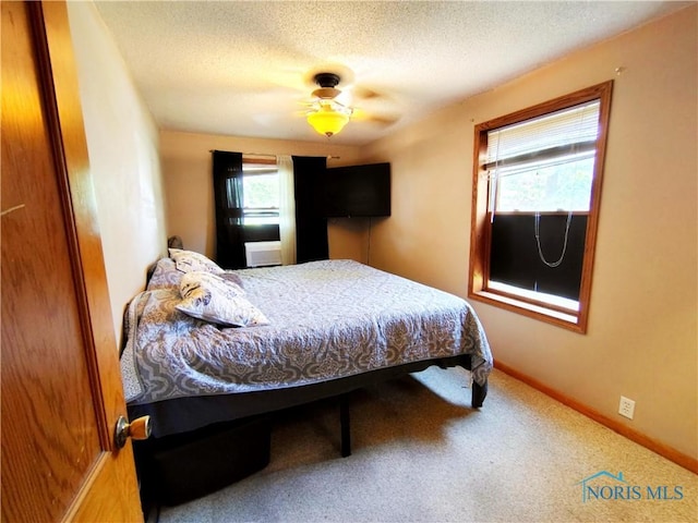 1050 Schultz St, Defiance, OH 43512 - carpeted bedroom with a textured ceiling and a ceiling fan
