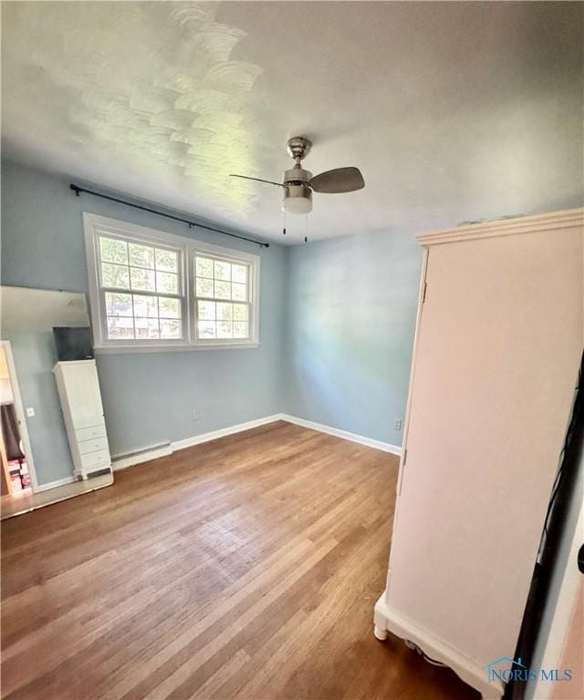 309 Koerber Dr, Defiance, OH 43512 - unfurnished living room featuring a ceiling fan and wood finished floors