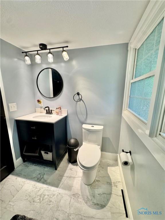 309 Koerber Dr, Defiance, OH 43512 - bathroom featuring marble finish flooring, vanity, a textured ceiling, and rail lighting