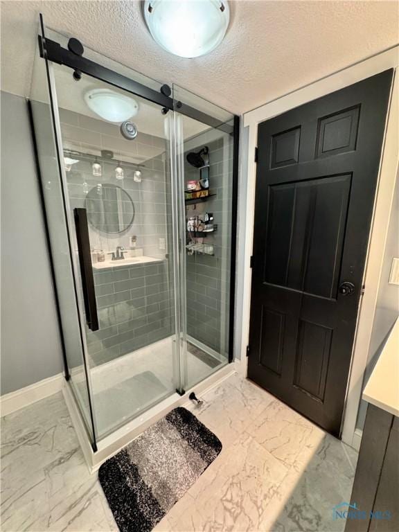 309 Koerber Dr, Defiance, OH 43512 - bathroom featuring marble finish floors, a textured ceiling, and a stall shower