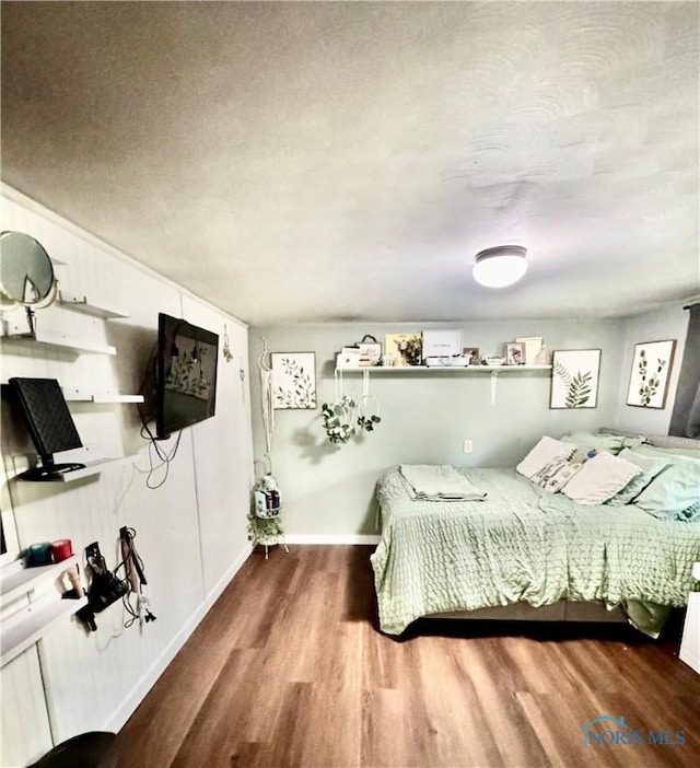 309 Koerber Dr, Defiance, OH 43512 - bedroom with wood finished floors and a textured ceiling