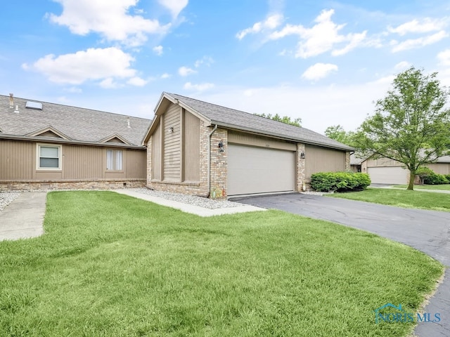 1104 Bernath Pkwy, Toledo, OH 43615 - view of front of home with driveway, a front yard, a garage, and brick siding