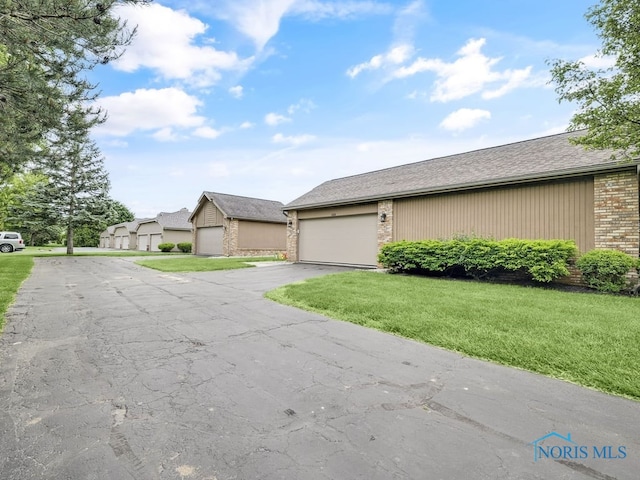 1104 Bernath Pkwy, Toledo, OH 43615 - view of front of property featuring brick siding and a front lawn
